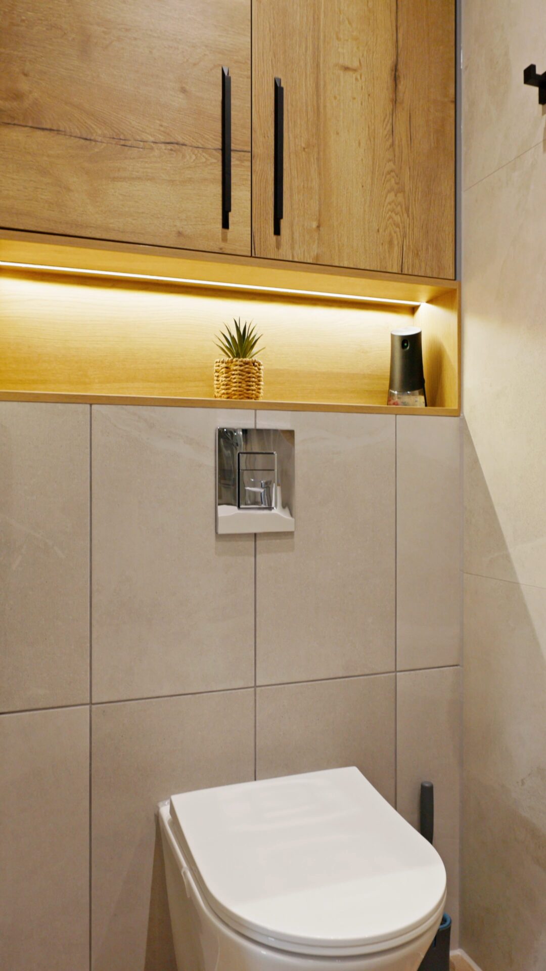 Cloakroom with wood-effect wall cabinets, under-cabinet lighting and a wall-hung toilet