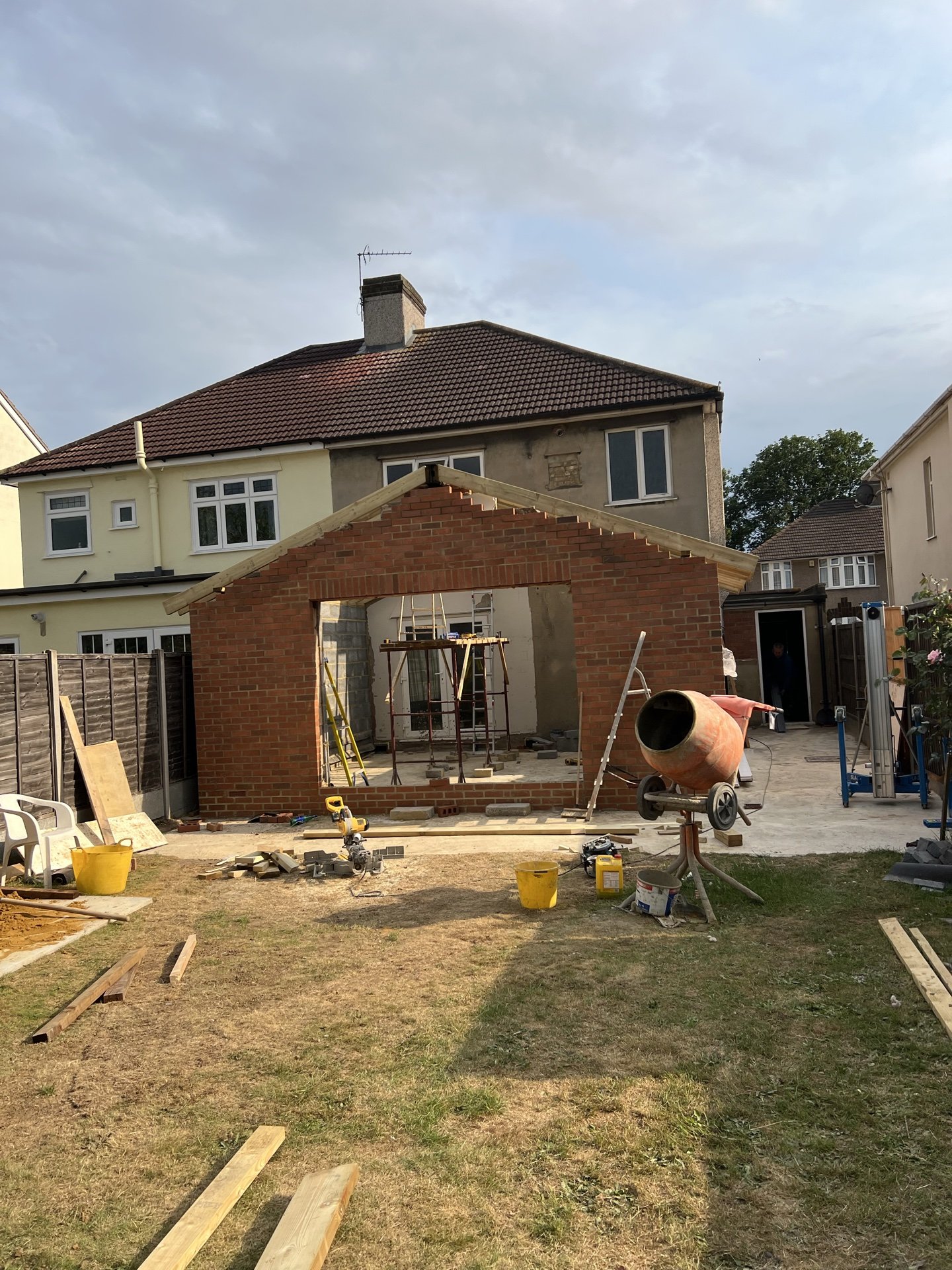 Gable brickwork going up on a rear extension, with the mixer on site, 1.4 miles from Welling