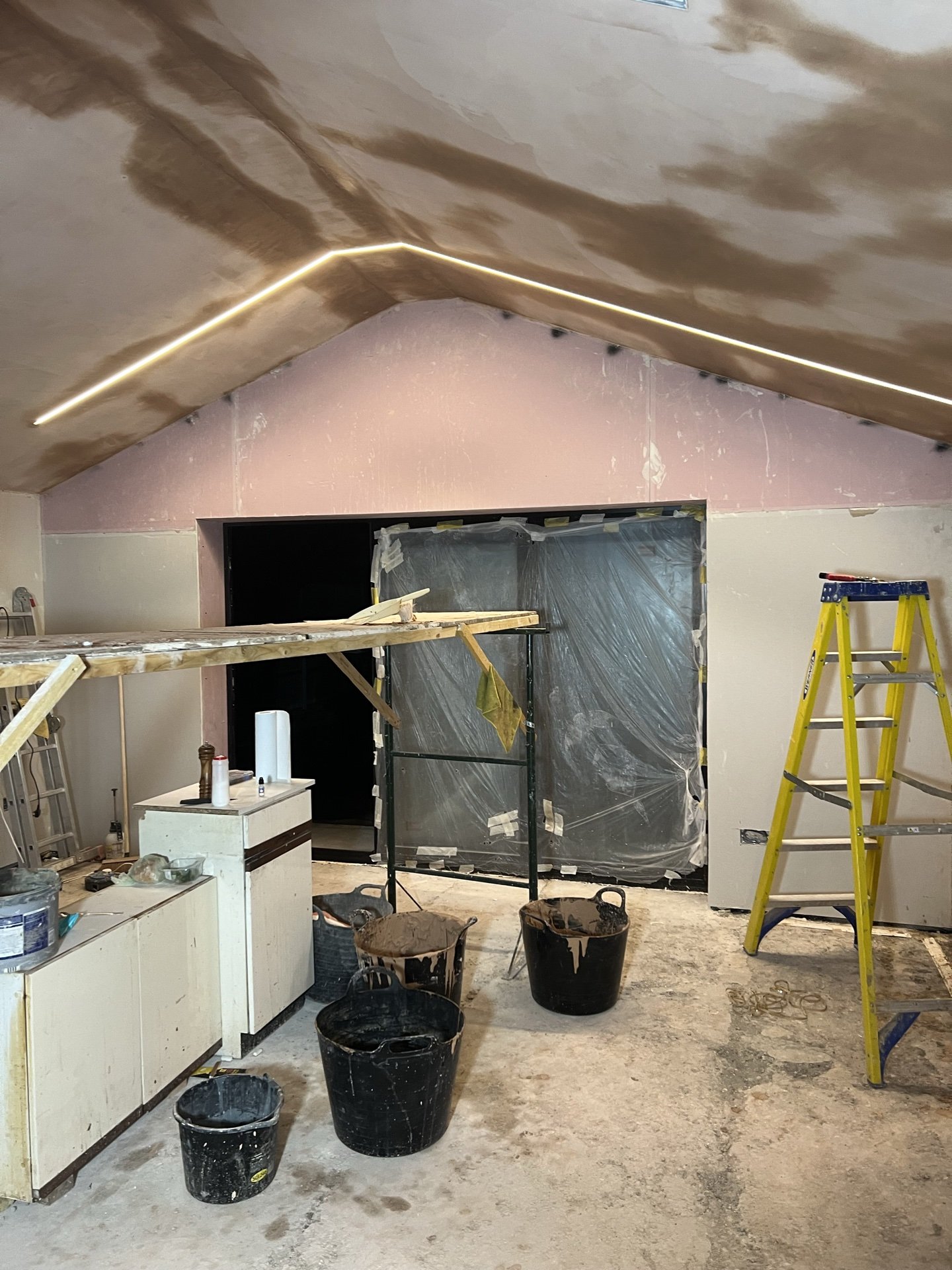 Kitchen extension at plastering stage, with the vaulted ceiling skimmed