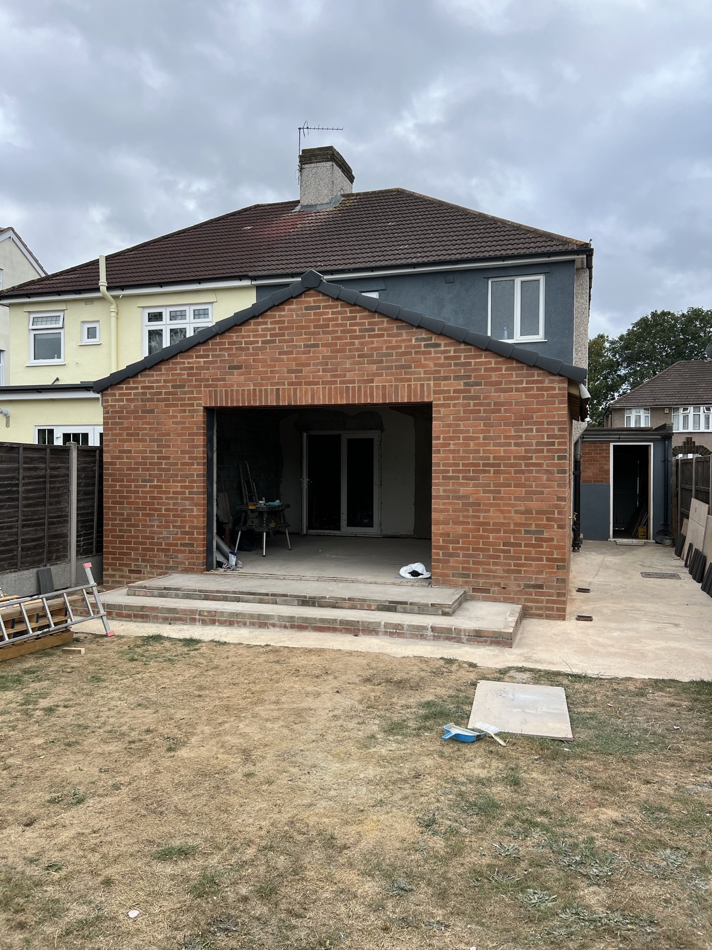 Rear elevation of a 1930s semi with a new brick extension built across the back