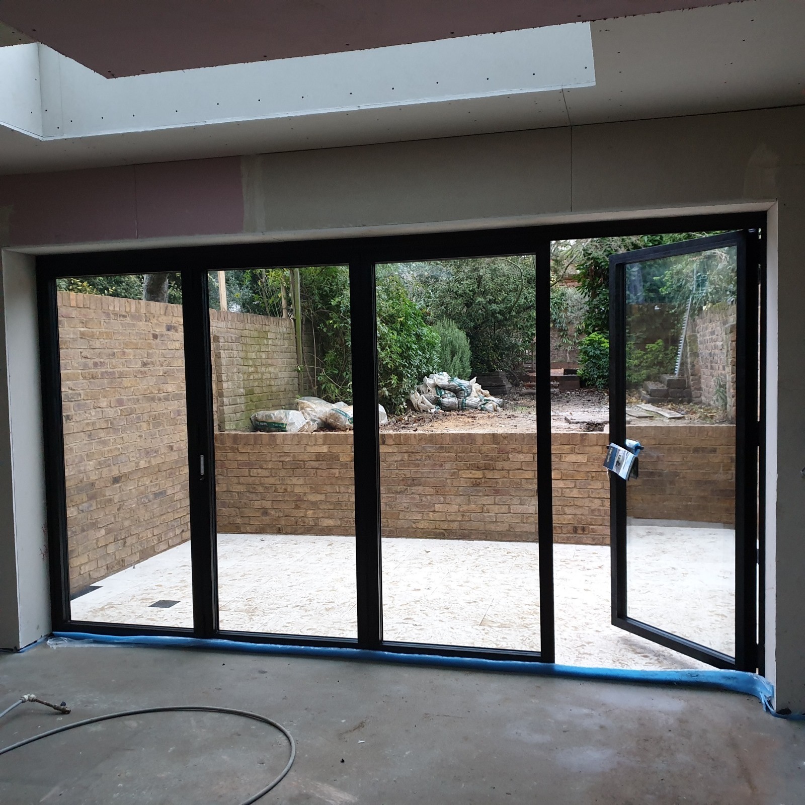 Bi-fold doors installed in a new kitchen extension before the floor goes down, Beckenham