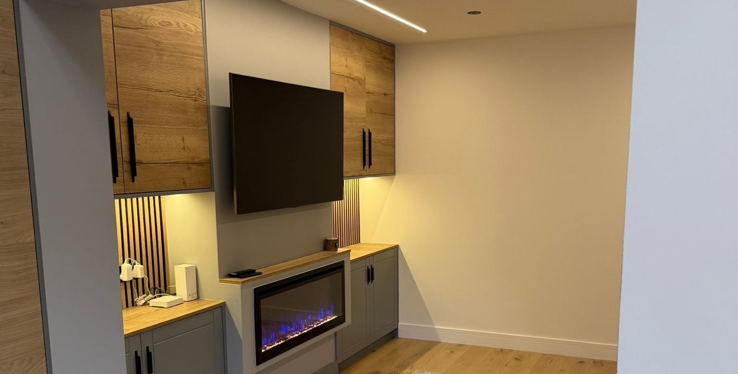 Finished media wall with oak cabinetry and an electric fire in the open-plan extension, 1.4 miles from Welling